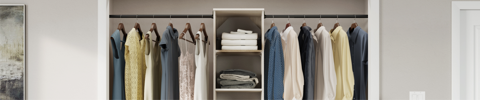 Clothes hang in a tidy, organized closet.